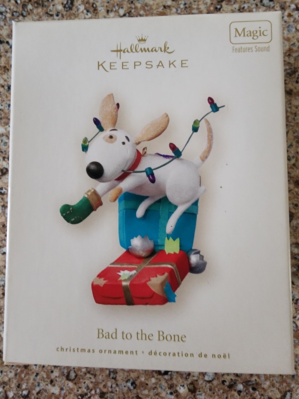 Hallmark White and Gold 'Bad to the Bone' Ornament Box Art